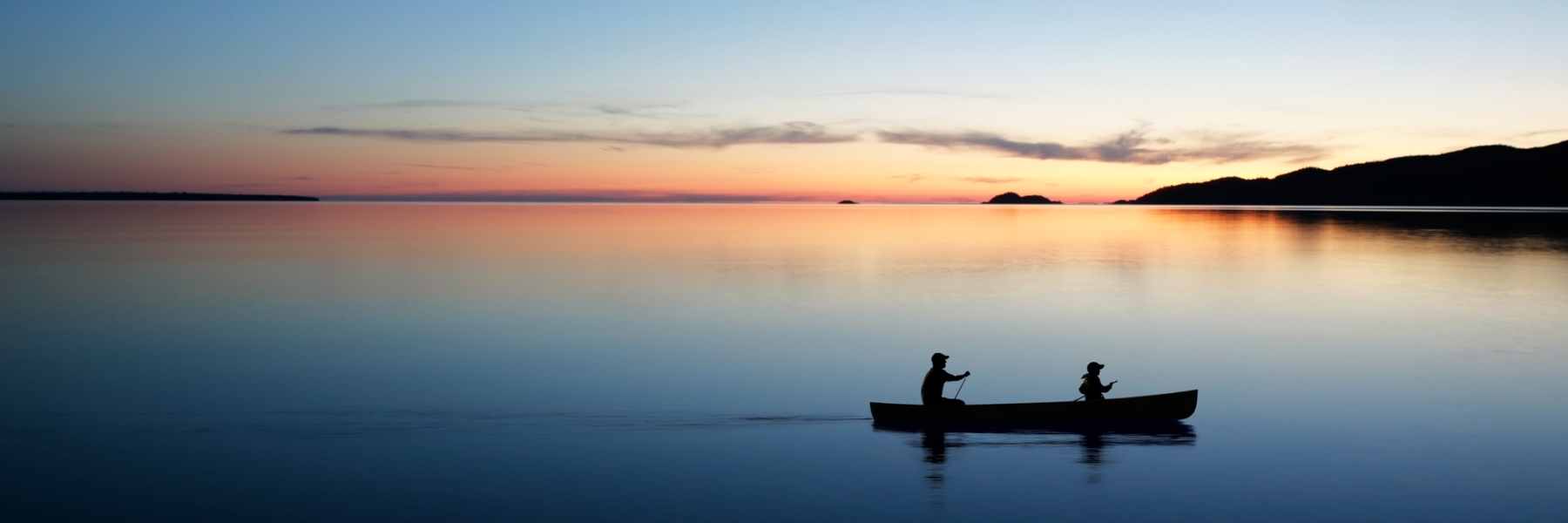 canoeing on a lake at sunset